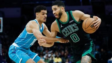 Boston Celtics forward Jayson Tatum (0) drives against Charlotte Hornets guard Josh Green during the second half of an NBA basketball game in Charlotte, N.C.,